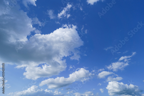 Beautiful bright blue sky and white fluffy clouds © pridannikov