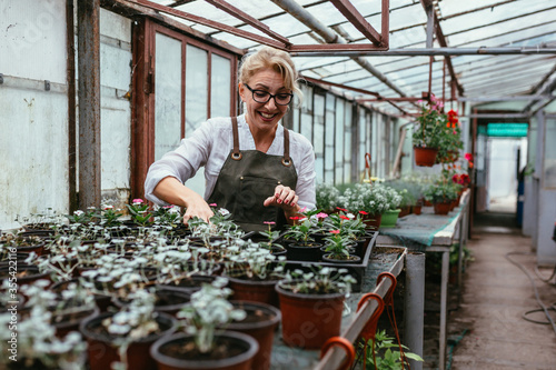 woman working in flower nursery.small family business concept