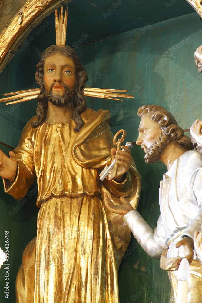Obraz premium Jesus gives the keys to St. Peter, a statue on the high altar in St. Peter's Parish Church in Sveti Petar Mreznicki, Croatia