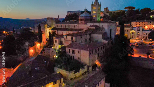 Fotografia Massa Marittima, Tuscany. Aerial view at night of medieval town