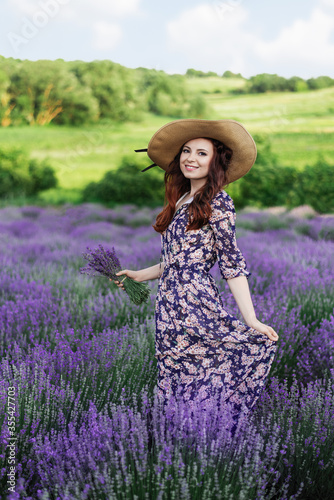 Beautiful healthy hair. Young teen girl brunette with long shiny hair over lavender field in Provence. Care and Beauty. Wellness concept.