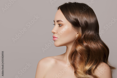Young beautiful woman side view. thick luxurious hair. hairstyle. Copycpase