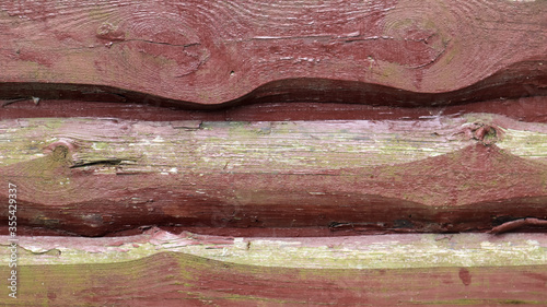 Walls from old planks painted brown, paneling overlapped each other as background. Abstract wooden background. The texture of the fence from unedged horizontal boards. Copy space, close-up. photo