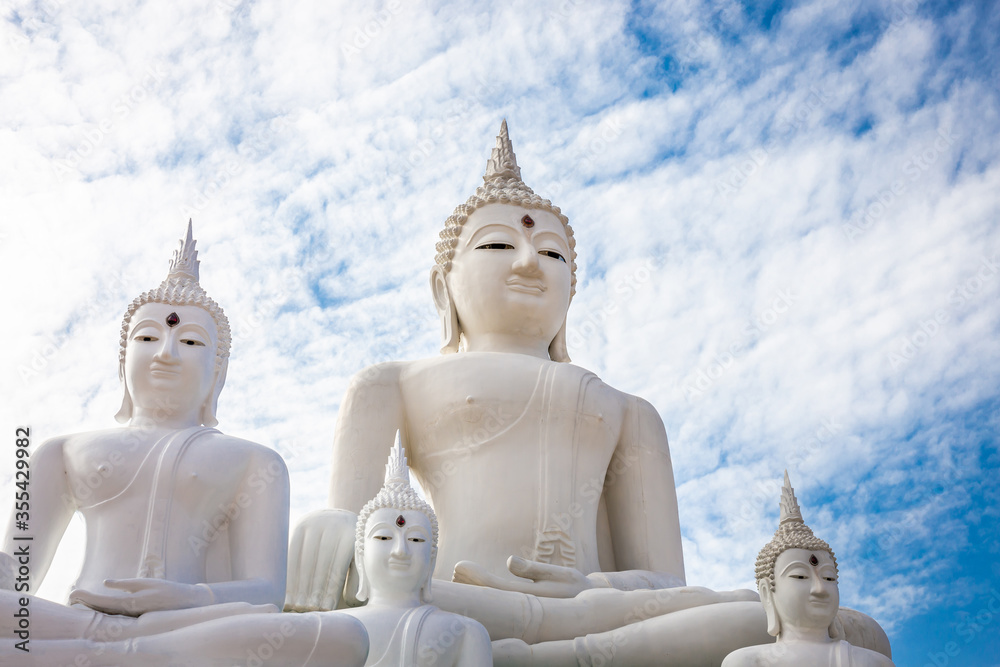 Many white Buddha on blue sky and cloud background Many white Buddha on blue sky and cloud background