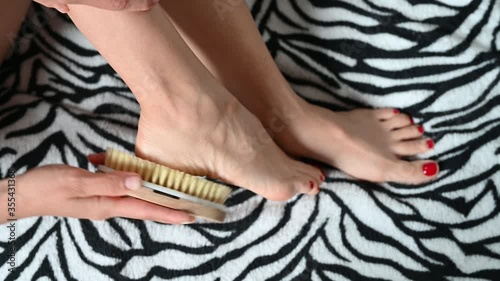 Girl massages the heels of the feet with a brush