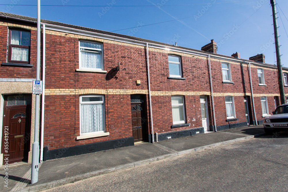 Traditional Red Brick Terraced Houses in Wales - street view with pavement.