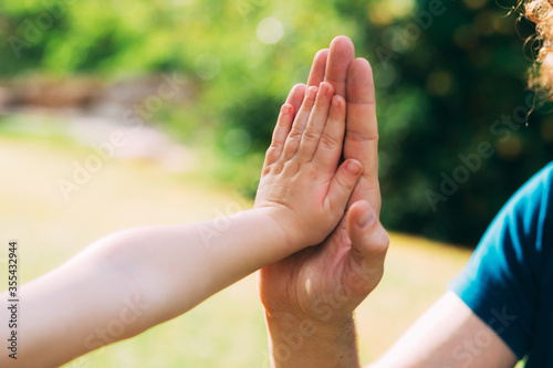 Father's day. Dad and son. Children's hand and father's hand, give five. Father and little boy. Hands of a child in the hand of an adult dad. Father gives 