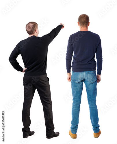 Back view of two man in sweater pointing.