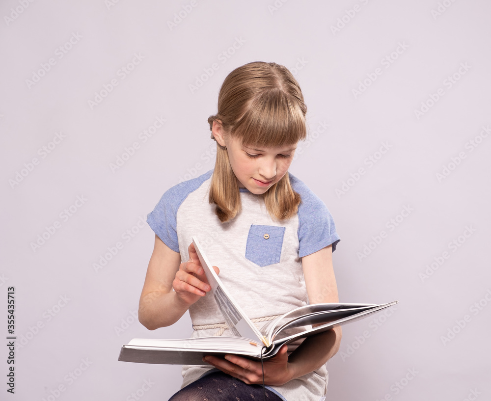 Teen girl reads a book