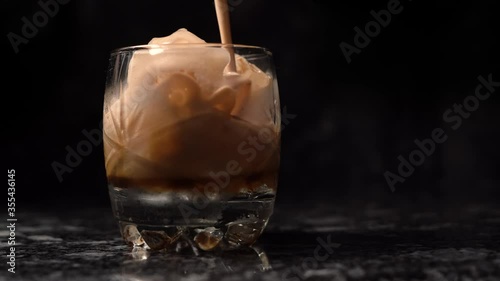 iced coffee in glass bottom with black background