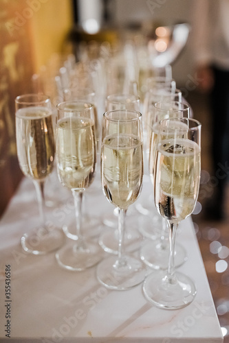 Glasses of champagne on the table. Vertical photo, holiday.