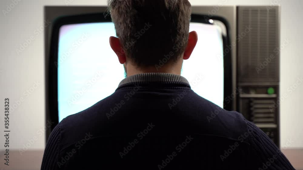 Unique retro television with blinking screen on white background. Noise