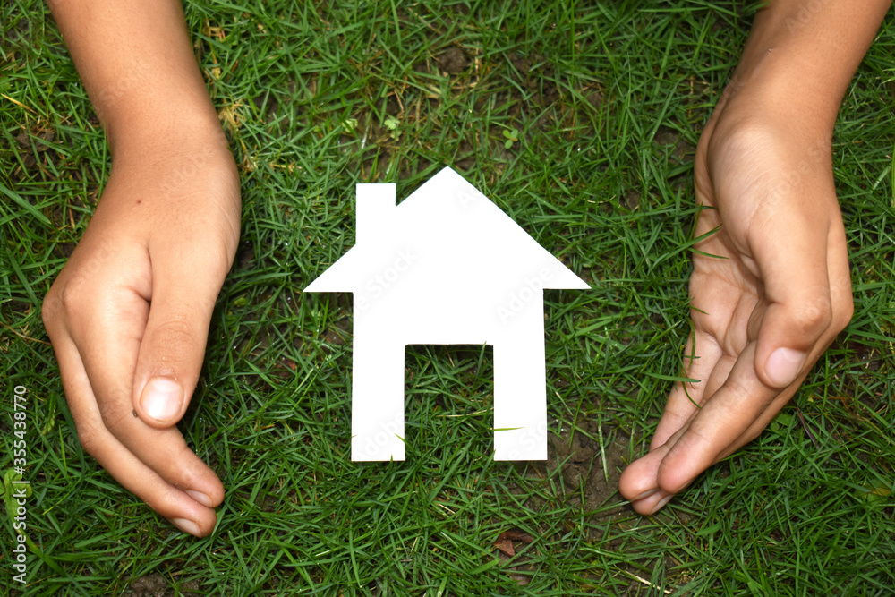 Papercut Family House in hand image Papercut Family House in hand image