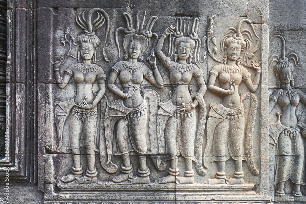 Female dancers carvings on the walls of Angkor Wat complex in Cambodia