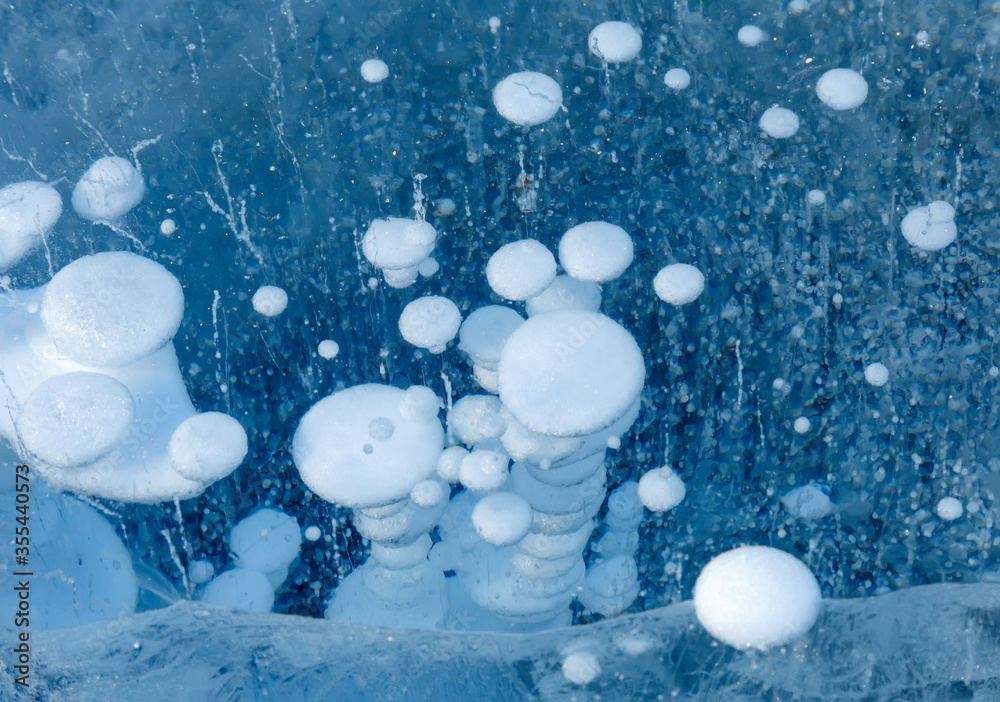 Bubbles of frozen gas methane in ice of Baikal lake Stock Photo | Adobe ...