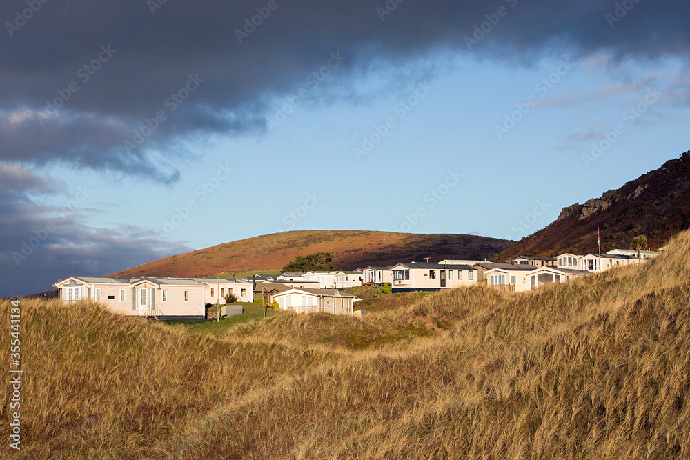 Static caravan holiday homes at Llangennith on the Gower Peninsular in winter which is out of season, the caravans are closed up until spring. Static caravan holiday homes at Llangennith on the Gower Peninsular in winter which is out of season, the caravans are closed up until spring.