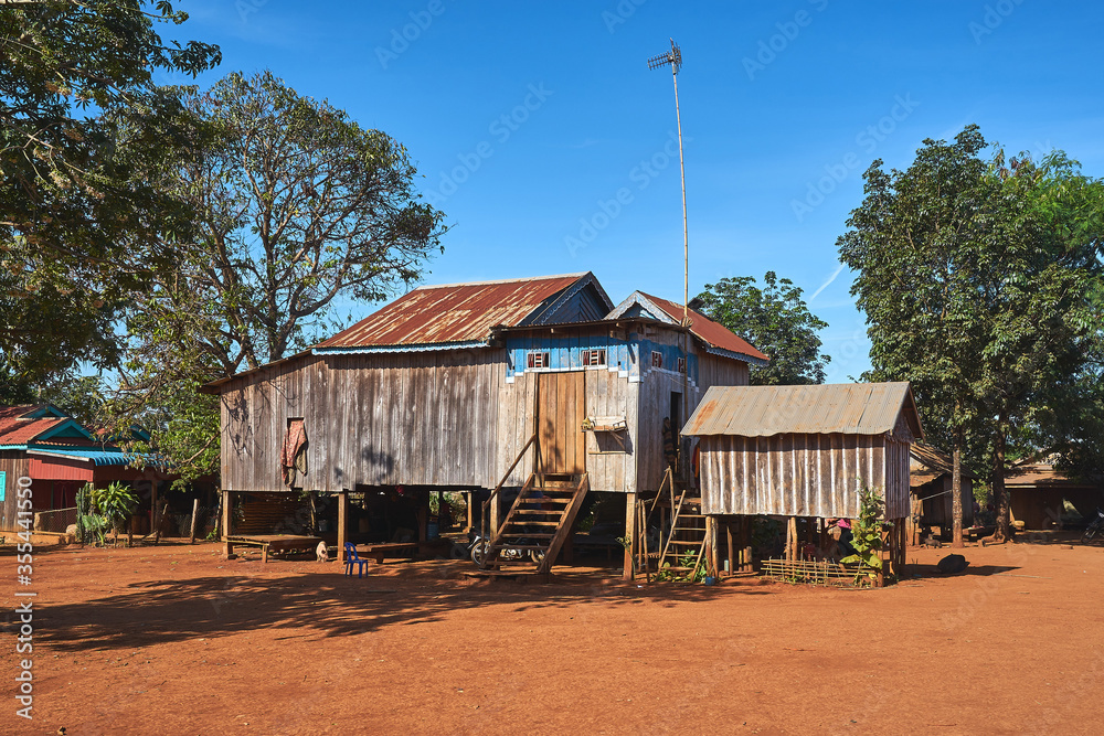 Traditional khmer stilt house with tv antenna in a cambodian village Traditional khmer stilt house with tv antenna in a cambodian village