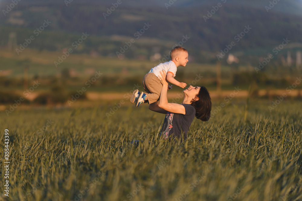 mother holding son in field mother holding son in field