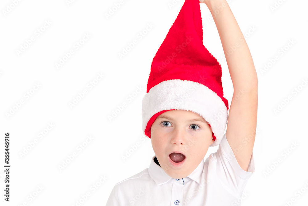 Close up Adorable boy with red hat of Christmas on a over white background Close up Adorable boy with red hat of Christmas on a over white background