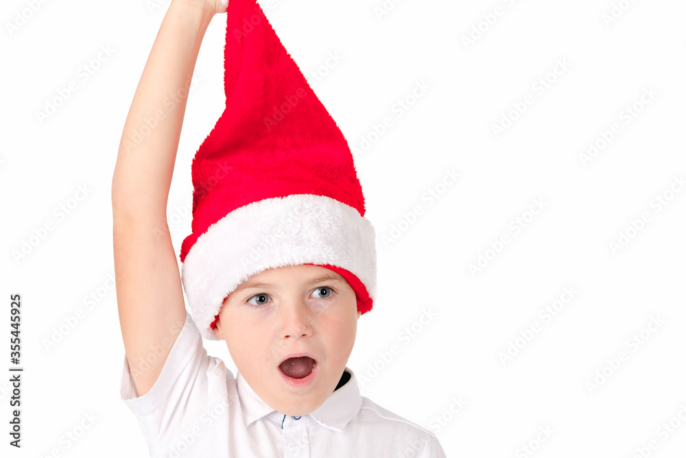 Close up Adorable boy with red hat of Christmas on a over white background Close up Adorable boy with red hat of Christmas on a over white background