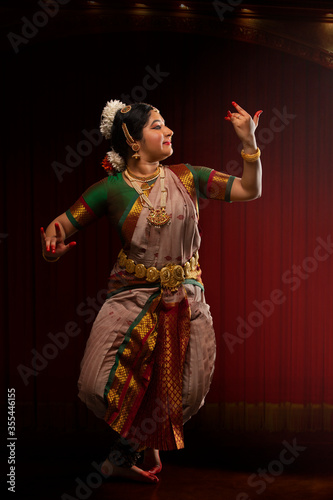 Bharatnatyam dancer playing veena during her graceful performance. 
 photo