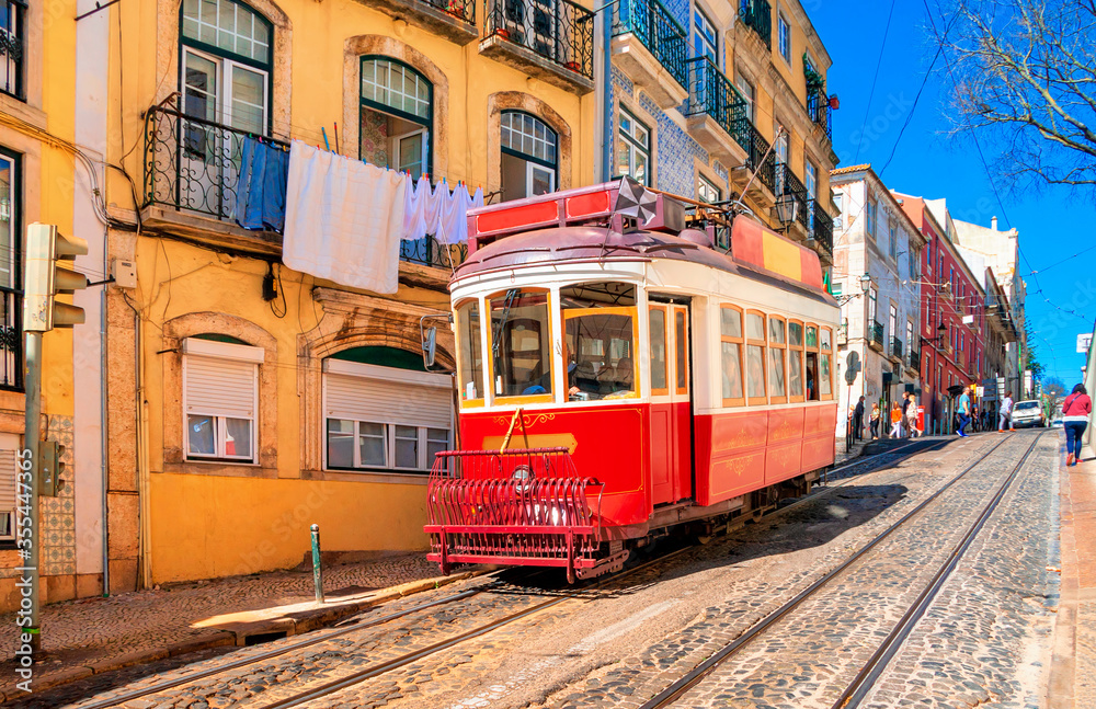 Vintage red tram on the old streets of Lisbon, Portugal. Portugal tram. Famous landmarks of Lisbon.