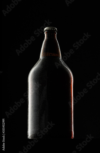 Beer bottle on dark background, copy space