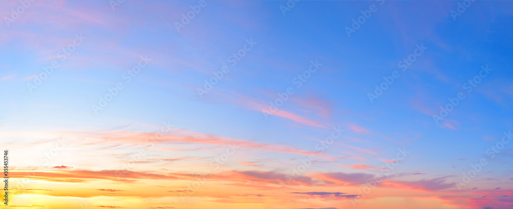 panorama of a blue-pink sunset with clouds of pink hues. sunset on the horizon. photo for the banner. space for text.