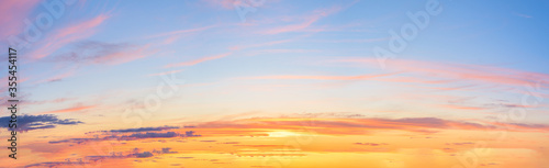 panorama of a blue-pink sunset with clouds of pink hues. sunset on the horizon. photo for the banner. space for text. © Taranova_ksenya