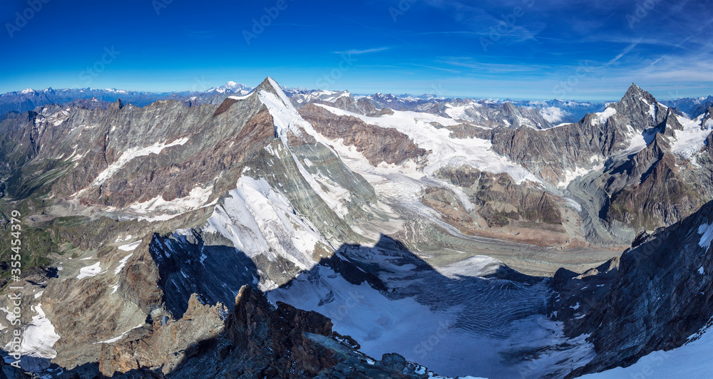 Alpine beautiful landscape. Panoramic view on Alps peaks and glacier. Lion ridge. Alpine beautiful landscape. Panoramic view on Alps peaks and glacier. Lion ridge.