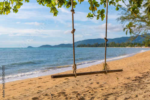 swing on the beach of the paradise island of Koh Samui in Thailand, a sunny beach, sunbathing and swimming in the sea, blue ocean and sky, travel to the resort, relaxation and enjoyment