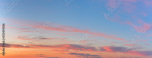 panorama of a blue-pink sunset with clouds of pink hues. sunset on the horizon. photo for the banner. space for text. © Taranova_ksenya