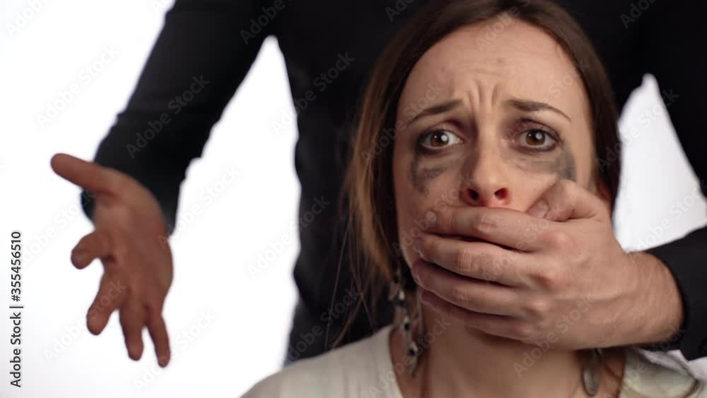 Domestic family violence, aggressive man attacking weak crying woman, closing her mouth, hurting her and screaming. Male's tyranny against female, physical cruelty in family. Suffering woman with Domestic family violence, aggressive man attacking weak crying woman, closing her mouth, hurting her and screaming. Male's tyranny against female, physical cruelty in family. Suffering woman with