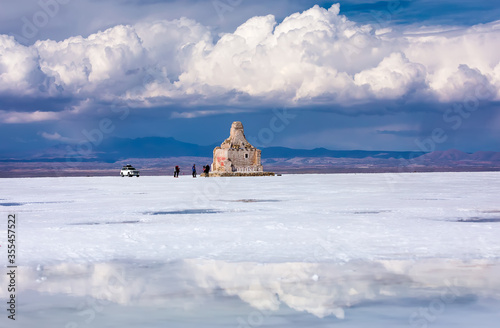 Stunning view on Salt flat of Uyuni with Statue Dakar Rally and reflection of clouds. Daniel Campos Province, Bolivia