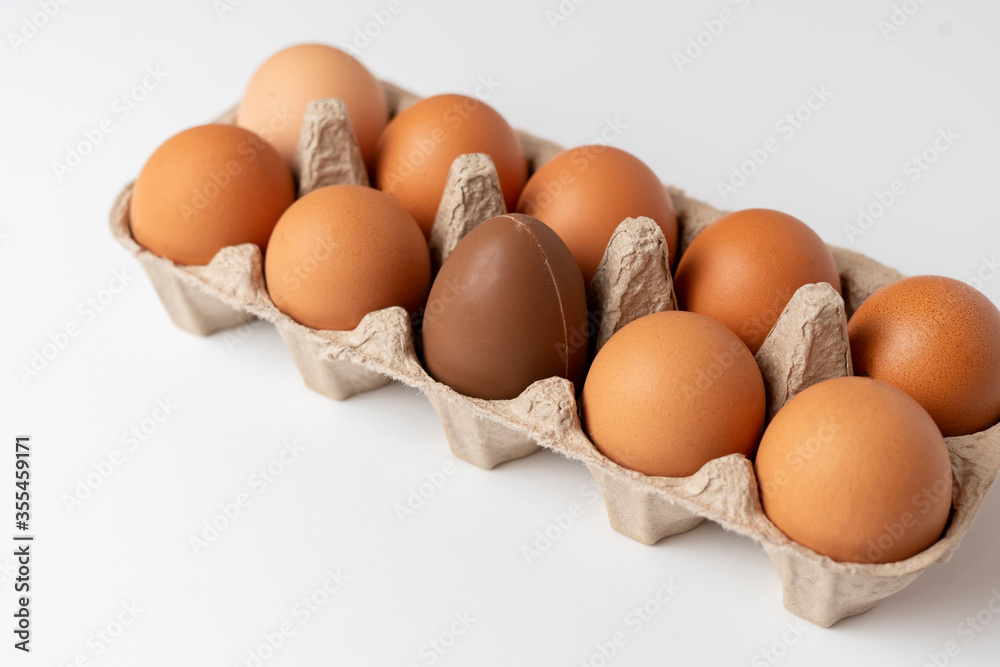 some raw chicken eggs in the tray with the ch, creative minimal conceptocolate egg