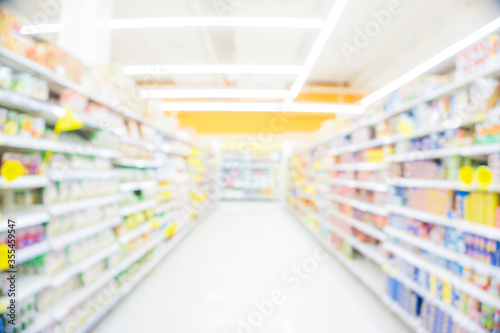 Blurred food and drink on shelf in super market with cart