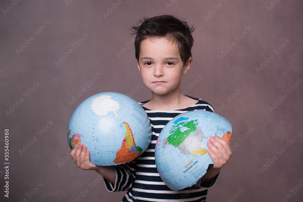 broken globe is held by child. concept. problems of life on earth. ecology, global warming, environmental pollution, business, closed borders, no travel. horizontal. copy space. portrait cute sad baby broken globe is held by child. concept. problems of life on earth. ecology, global warming, environmental pollution, business, closed borders, no travel. horizontal. copy space. portrait cute sad baby
