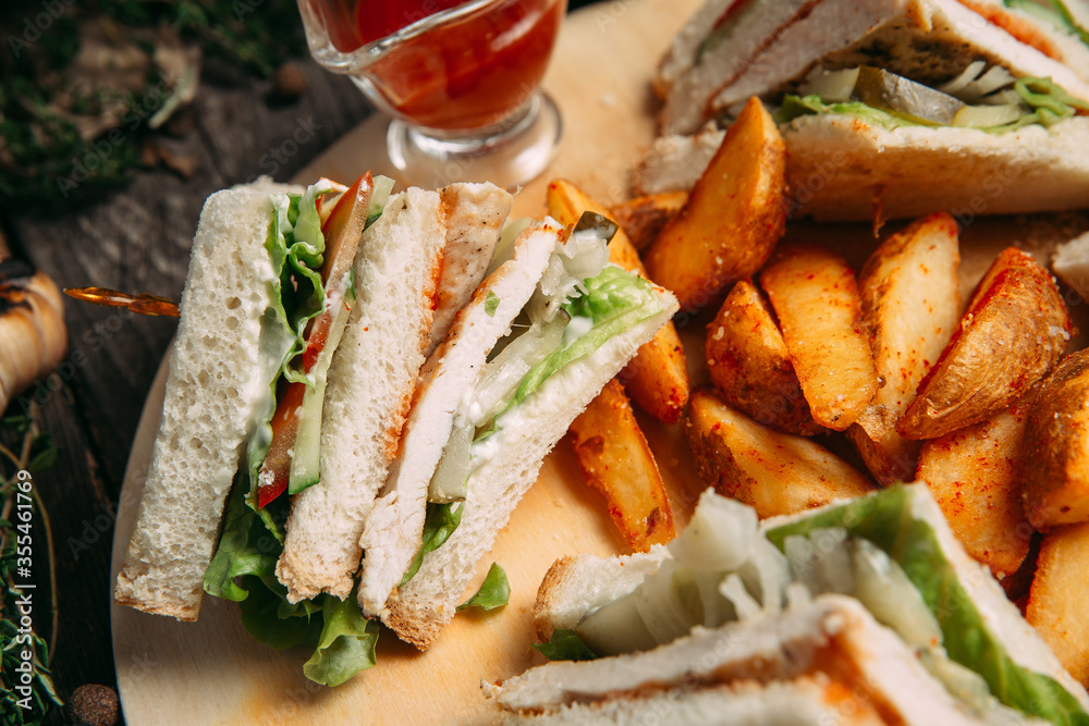 Sandwiches set with red sauce rustic potato wedges Sandwiches set with red sauce rustic potato wedges