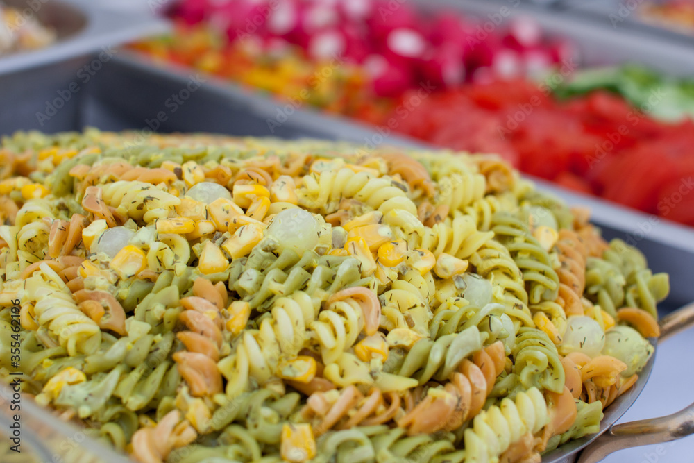 Colorful pasta salad in a buffet setup at a barbecue Stock Photo