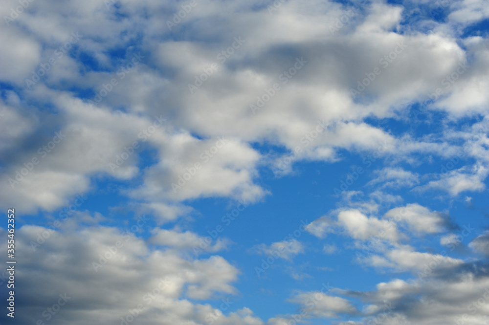 Obraz premium Blue summer sky with white clouds. Horizontal photo.