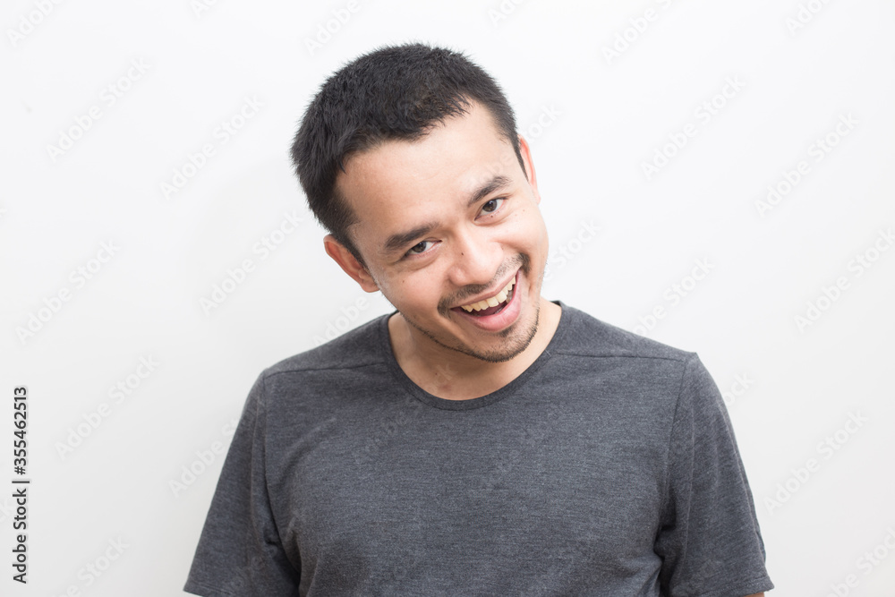 Smiling smart young asian man in gray short sleeve t-shirt Smiling smart young asian man in gray short sleeve t-shirt
