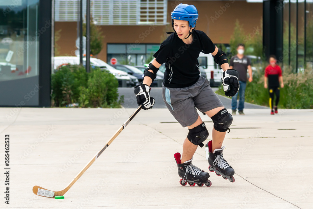 Outdoor sport, ice hockey player off ice practice on rollerskates Stock ...