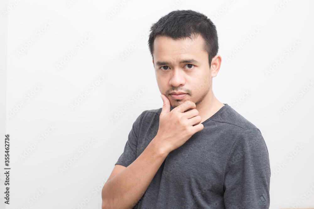 Smiling smart young asian man in gray short sleeve t-shirt Smiling smart young asian man in gray short sleeve t-shirt