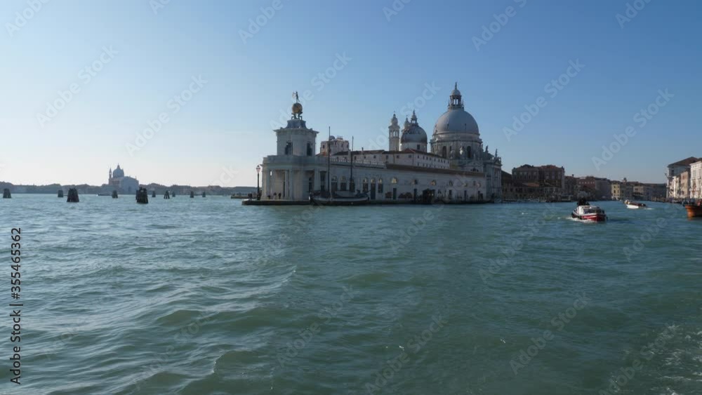 Cinematic shot of Grand Canal in Venice from boat on sunny day.