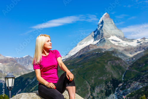 Woman hikers in the Alps, Matterhorn peak in Switzerland