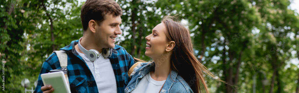 horizontal image of cheerful and young students looking at each other horizontal image of cheerful and young students looking at each other