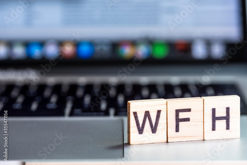 WFH letters on a laptop keyboard to denote Working From Home. An increasingly common change in business practice in response to the global pandemic.