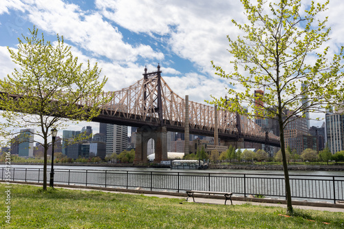 Queensbridge Park along the East River with the Queensboro Bridge and Green Trees during Spring in Long Island City Queens New York