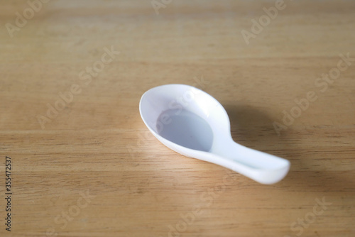 plastic spoon on wooden table