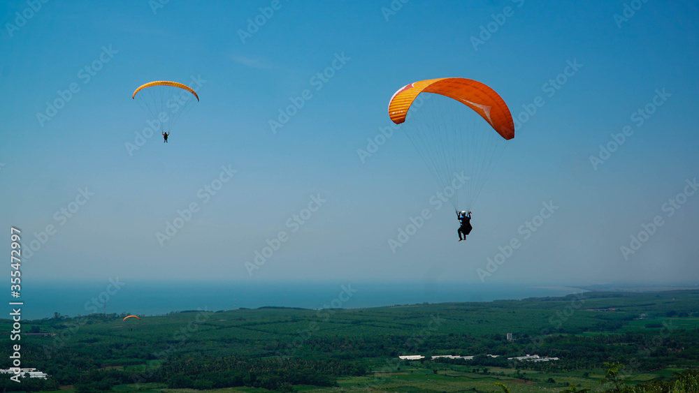 Paragliding flying in the blue sky. Paragliding flying in the blue sky.